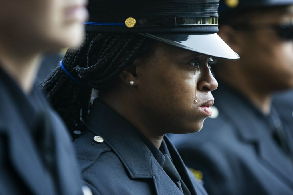 Award of Excellence, General News - Rebecca Benson / The Blade, “Dia Funeral”A Toledo Police Officer cries as officers carry slain Toledo Police Officer Anthony Dia into Savage Arena at the University of Toledo on July 7, 2020. Toledo Police Officer Dia was killed in the line of duty in the early morning of July 4th. 